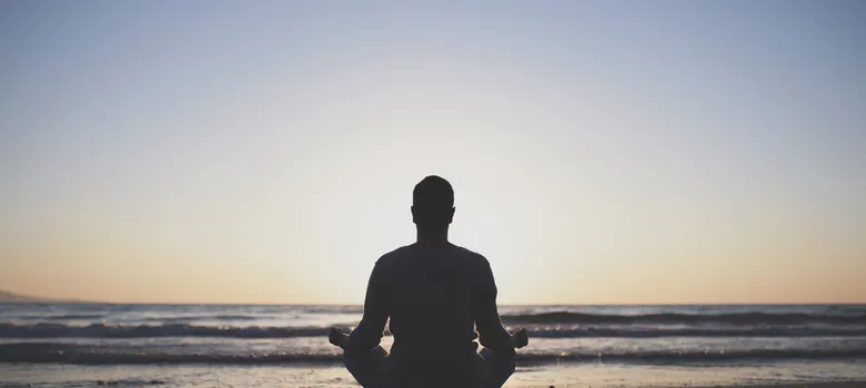 Young man practice yoga beach sunset.