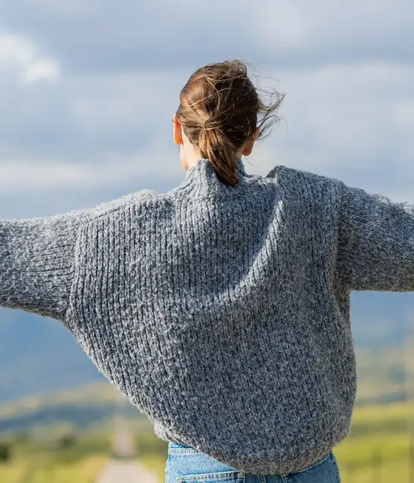 liberty environment woman gray sweater jeans stands road enviroment
