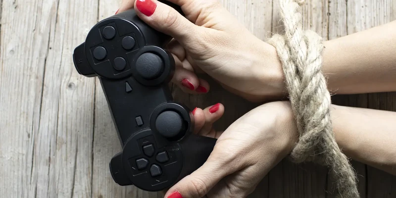 liberty gaming addiction two hands holding video game controller