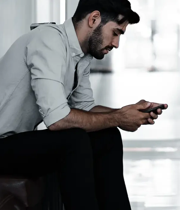 liberty internet addiction man sitting chair looking phone
