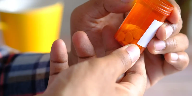 liberty opioid person holding pill hand