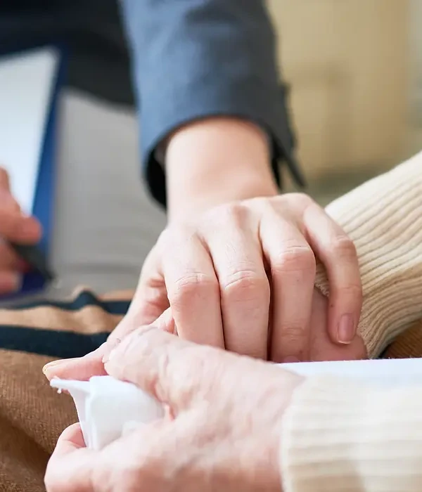 liberty therapy couple holding hands while sitting couch