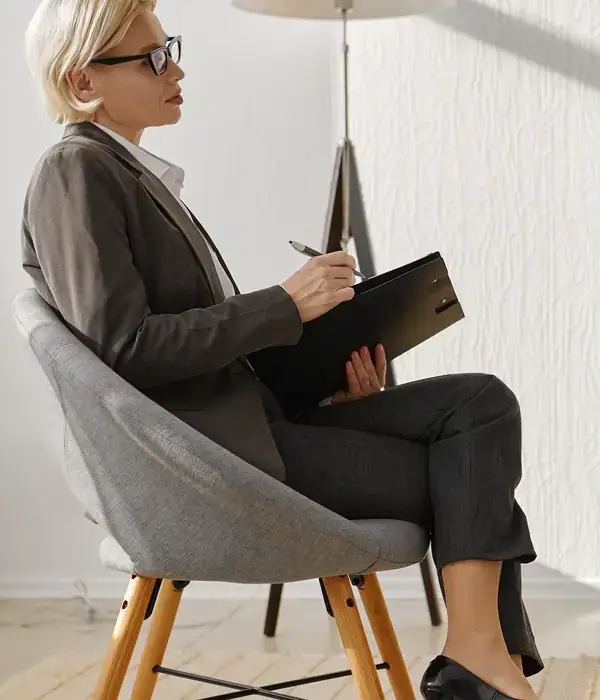 liberty therapy woman sitting chair book