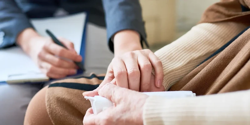liberty therapy woman sitting couch writing