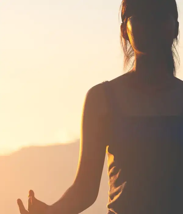 liberty yoga woman pose sun setting behind