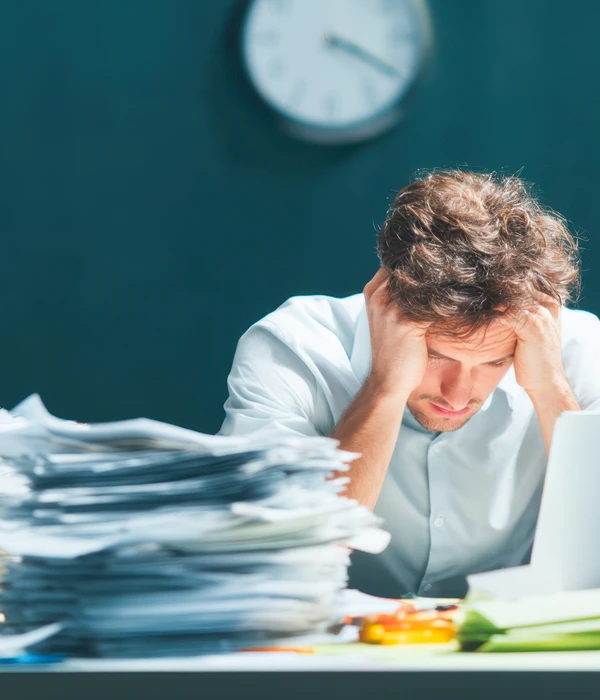 liberty-mental-health-man-sitting-desk-laptop-papers-page