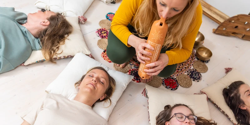 Group therapy session focused on mental wellness, with participants resting and guided through a calming therapeutic practice that promotes emotional balance, relaxation, and mindfulness during Mental Wellness Month.