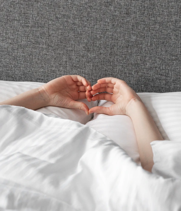 person laying bed hands