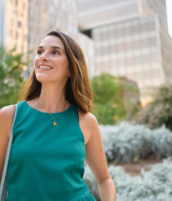 liberty-environment-woman-green-dress-smiles-while-walking-street-page