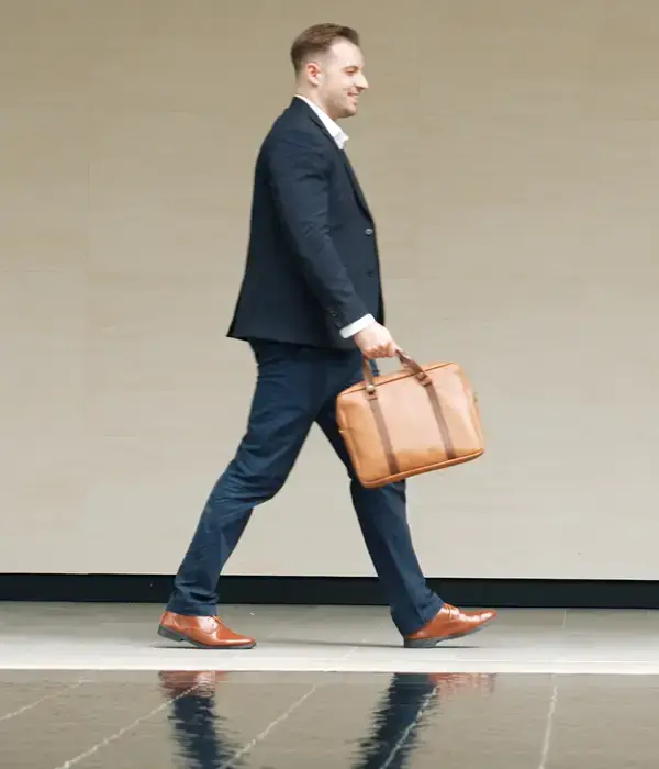 liberty-executive-man-suit-tie-walking-briefcase-page