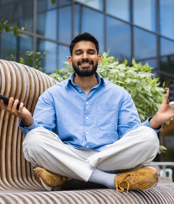 liberty-yoga-man-sitting-couch-using-cell-phone-page